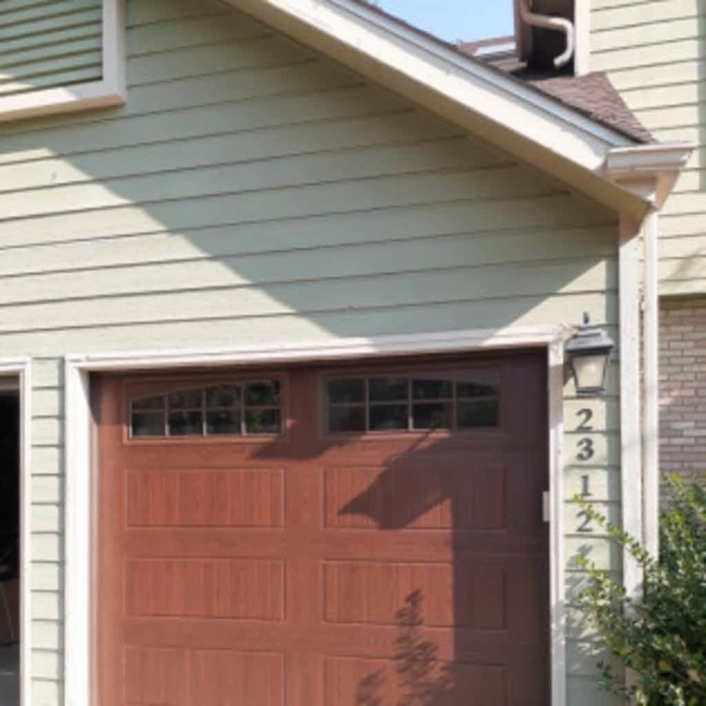 Nice brown garage door on tan vinyl house