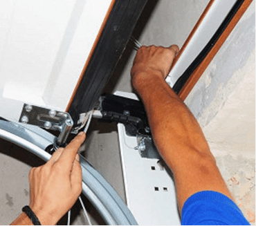 Employee fixing a garage door