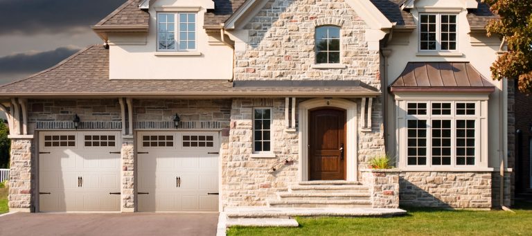 white grooved panel garage door on a modern rustic house