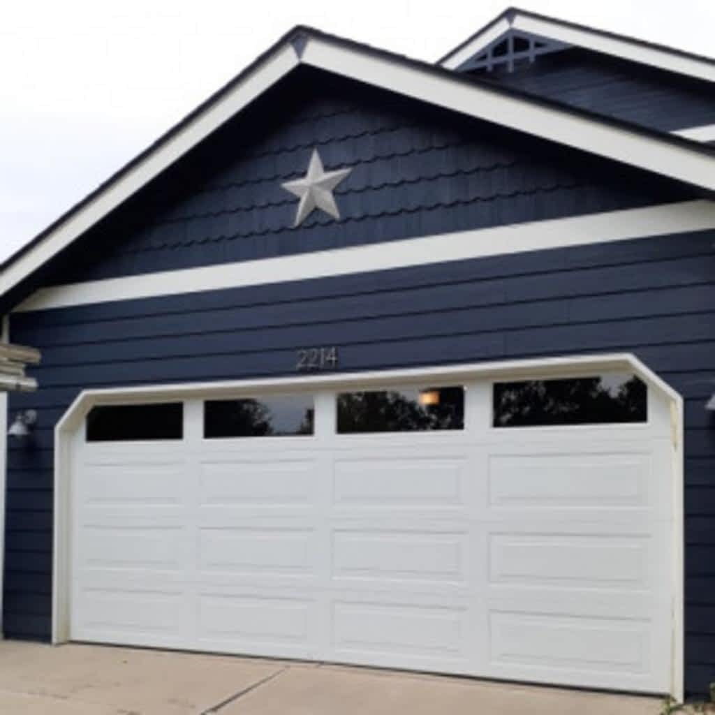 White garage door on blue house