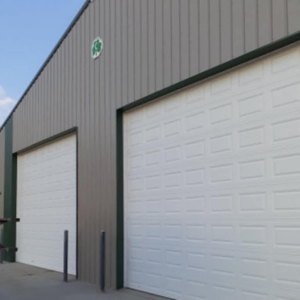 Two large garage doors on large grey building