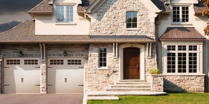 white grooved panel garage door on a modern rustic house